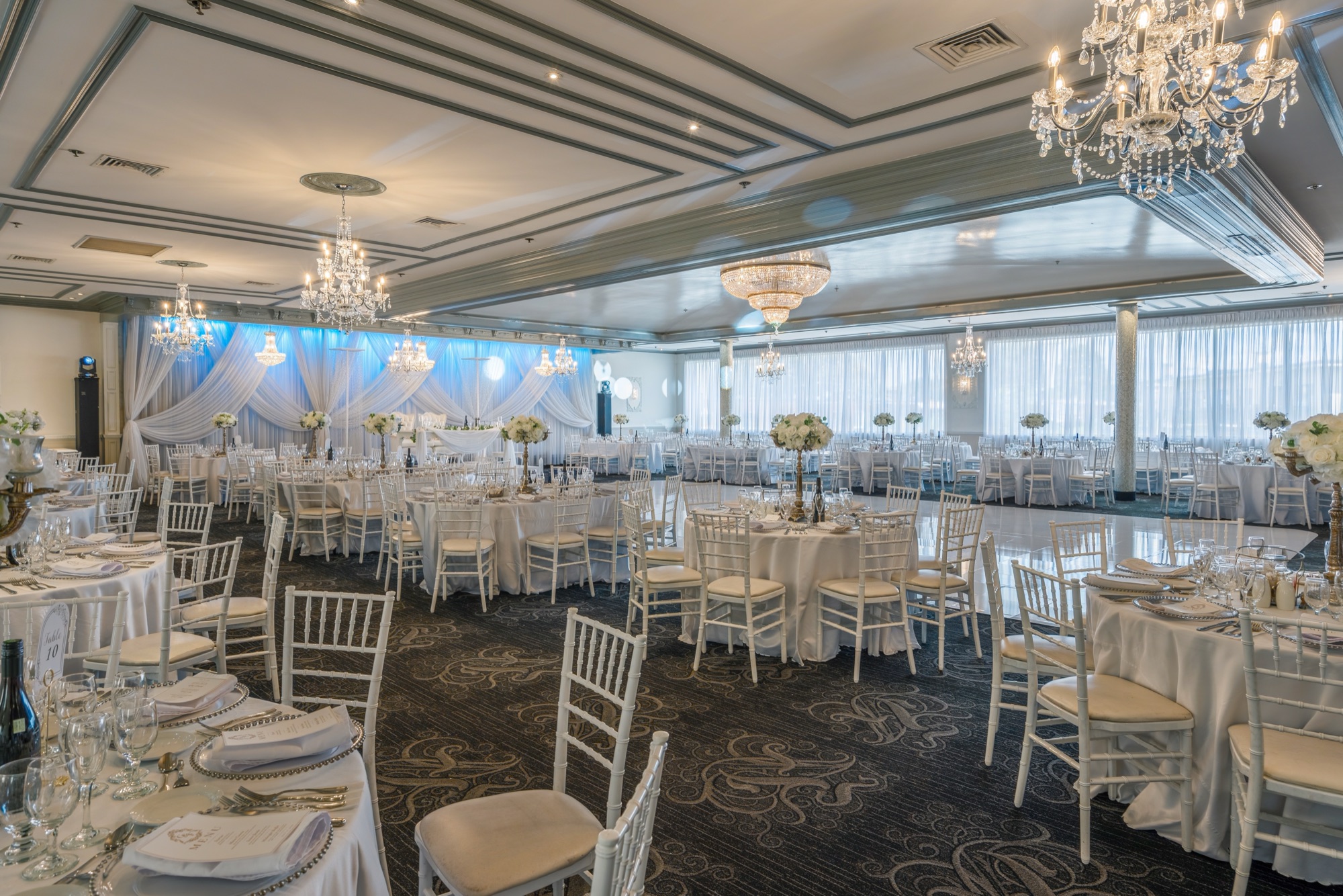 Bright hall arranged with white tables